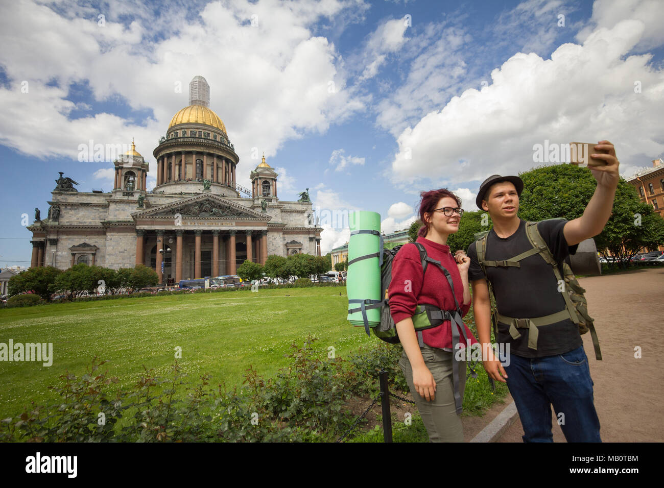 Two caucasian hikers taking selfies in front of historic cathedral ...