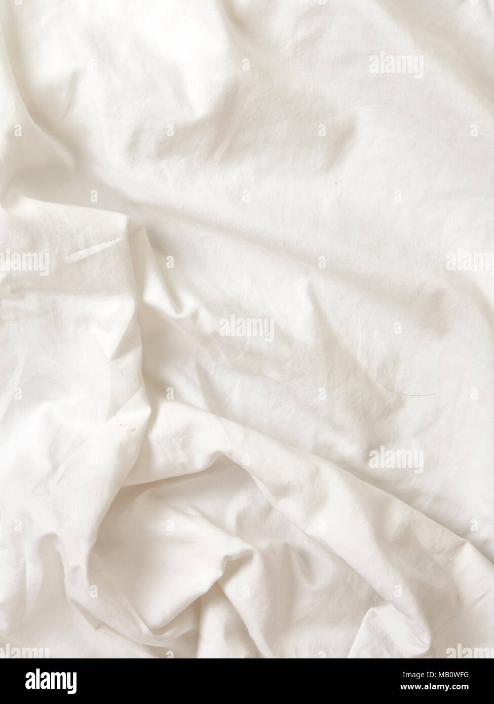 White wrinkled cotton fabric bed sheets textured background Stock Photo -  Alamy