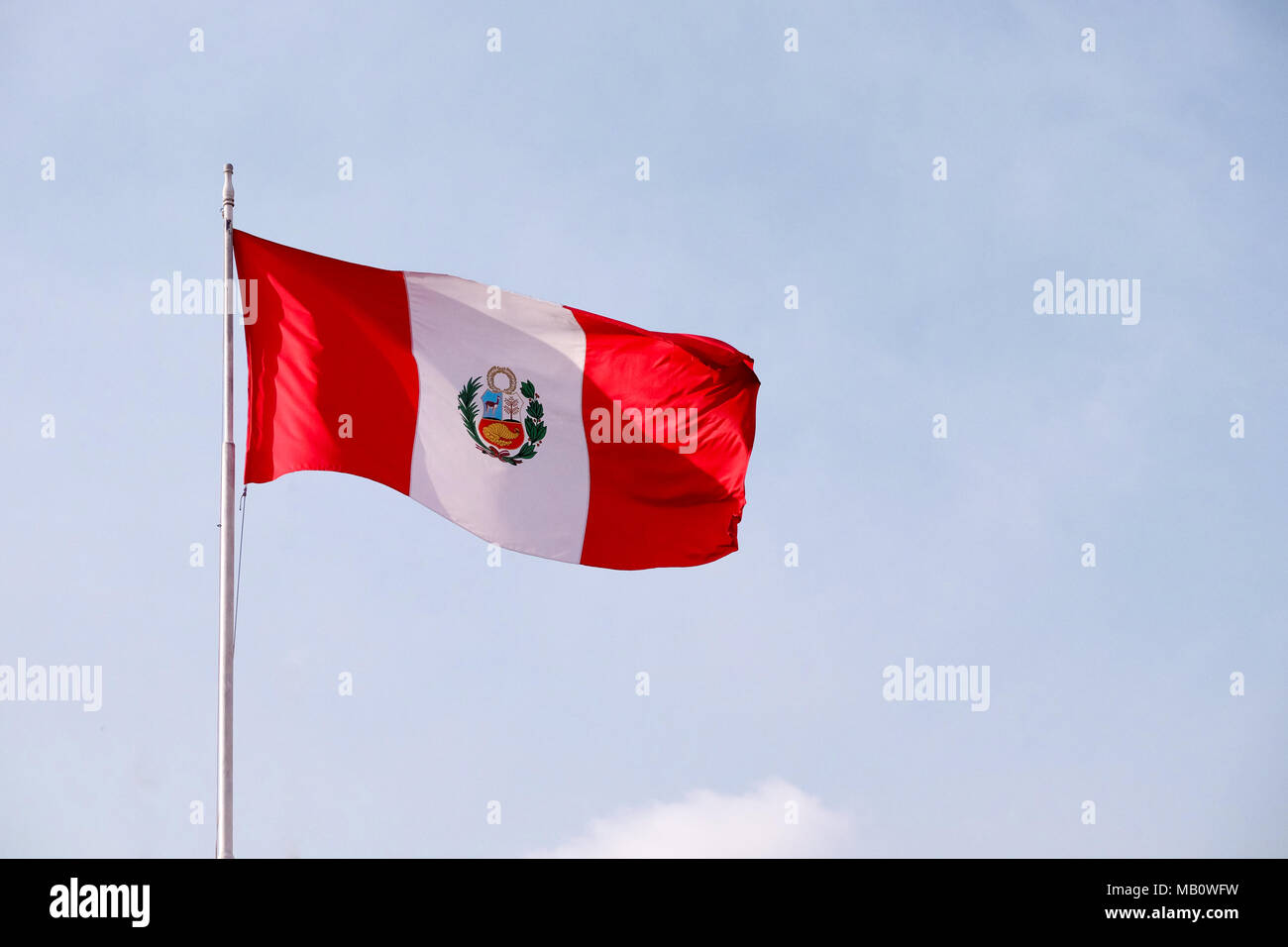 A large Peruvian flag waving in the wind in Peru. Stock Photo
