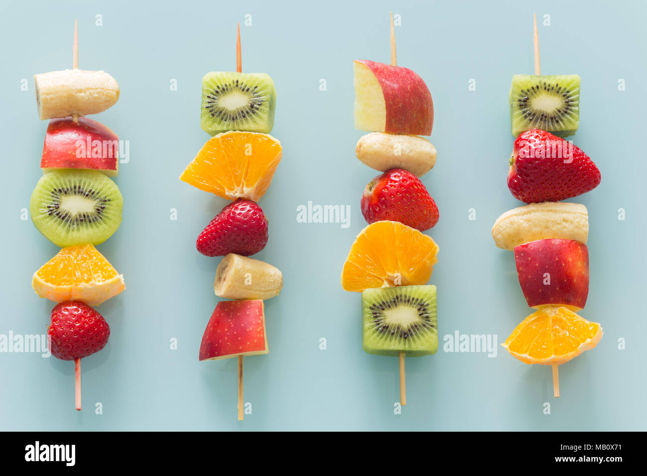 fruit skewers the concept of healthy eating / pastel turquoise glass background Stock Photo