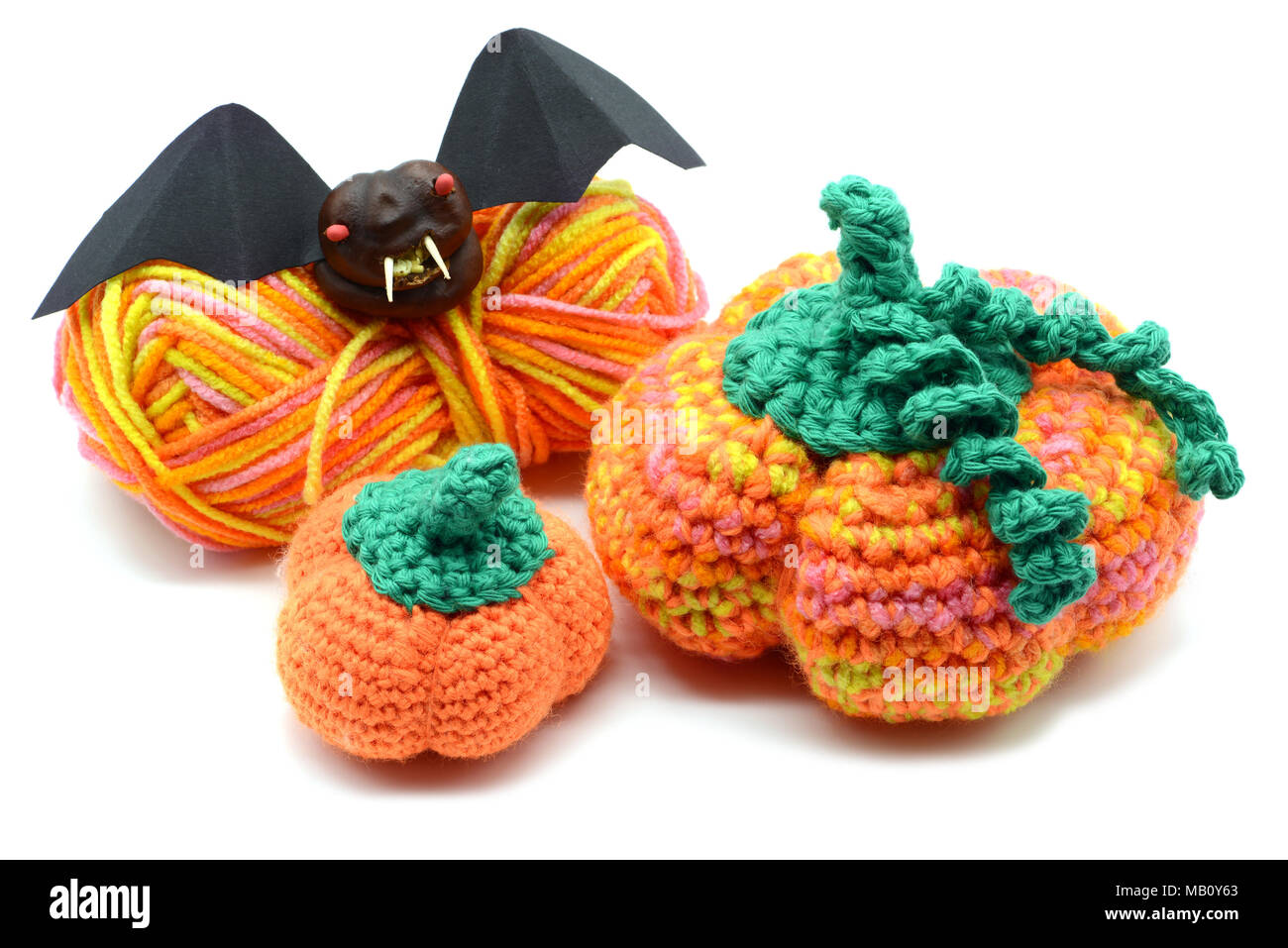 Autumn decoration crochet pumpkin and halloween bat of chestnut. Stock Photo