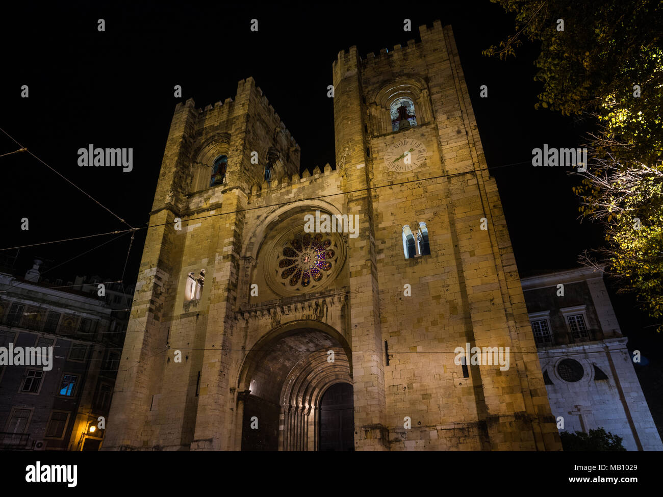Night view of the beautiful medieval facade of Cathedral of Saint Mary Major in Lisbon, built in the 12th century Stock Photo