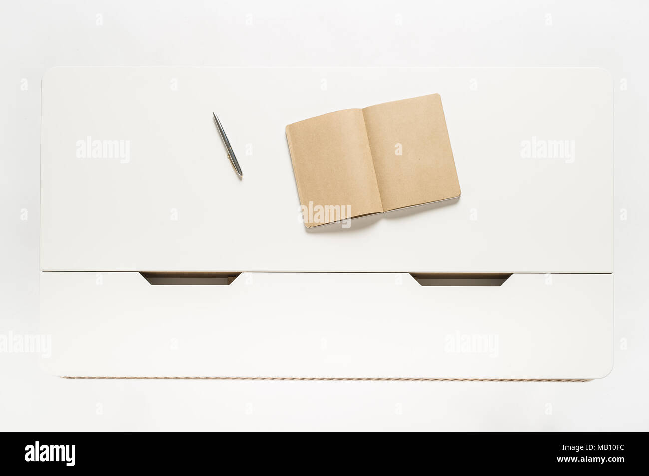 Notebook on white table in white background Stock Photo