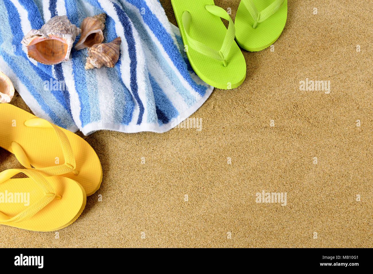 Beach background with towel and flip flops Stock Photo - Alamy
