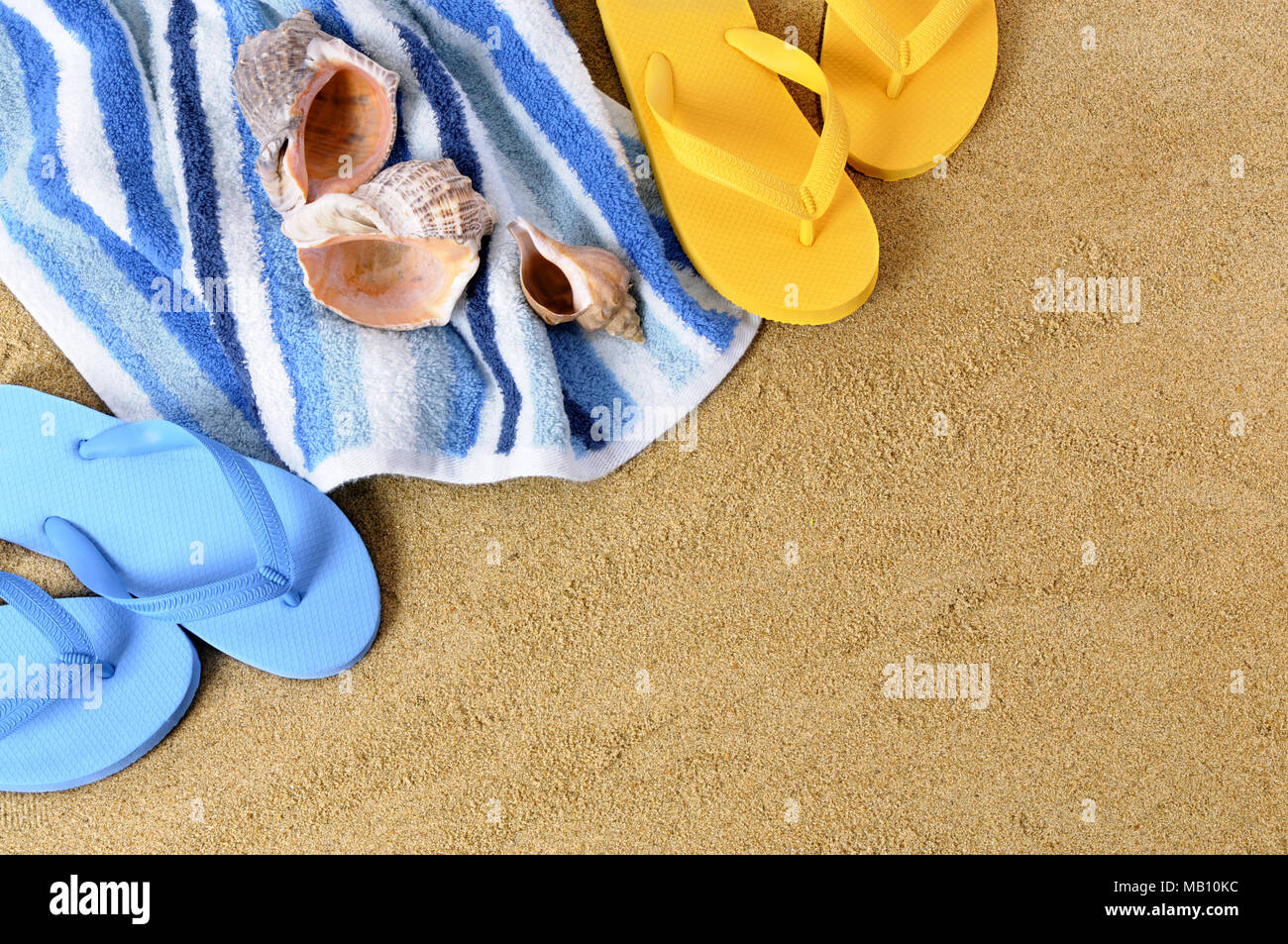 Beach background with towel and flip flops Stock Photo - Alamy
