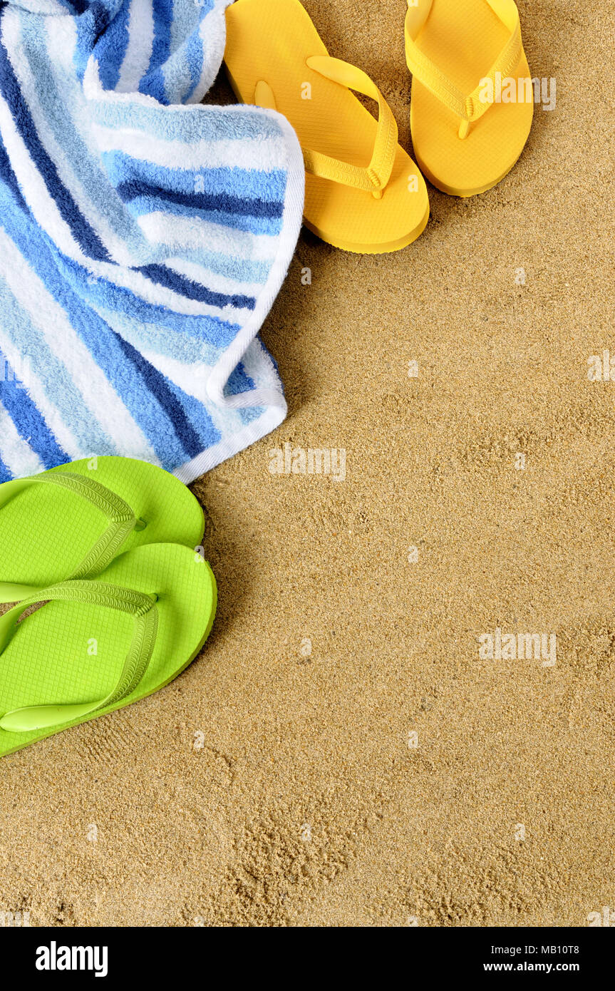 Beach background with towel and flip flops Stock Photo - Alamy