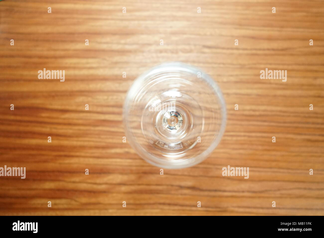 Empty wine glass, isolated on a brown background table Stock Photo