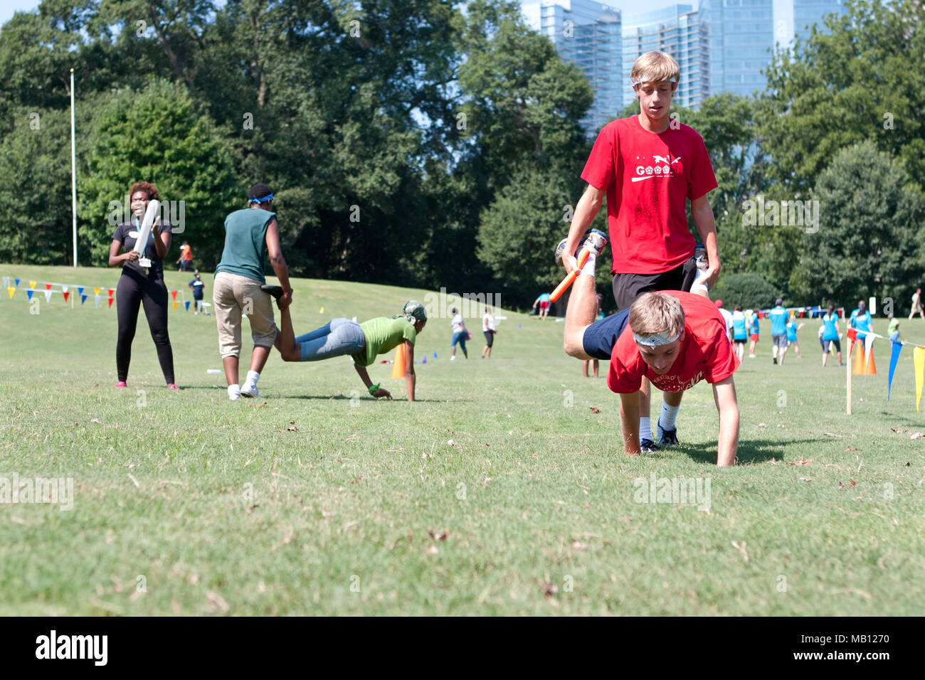Two young men compete in the wheelbarrow race at A Day For Kids, a charity  event on September 7, 2013 in Atlanta, GA Stock Photo - Alamy