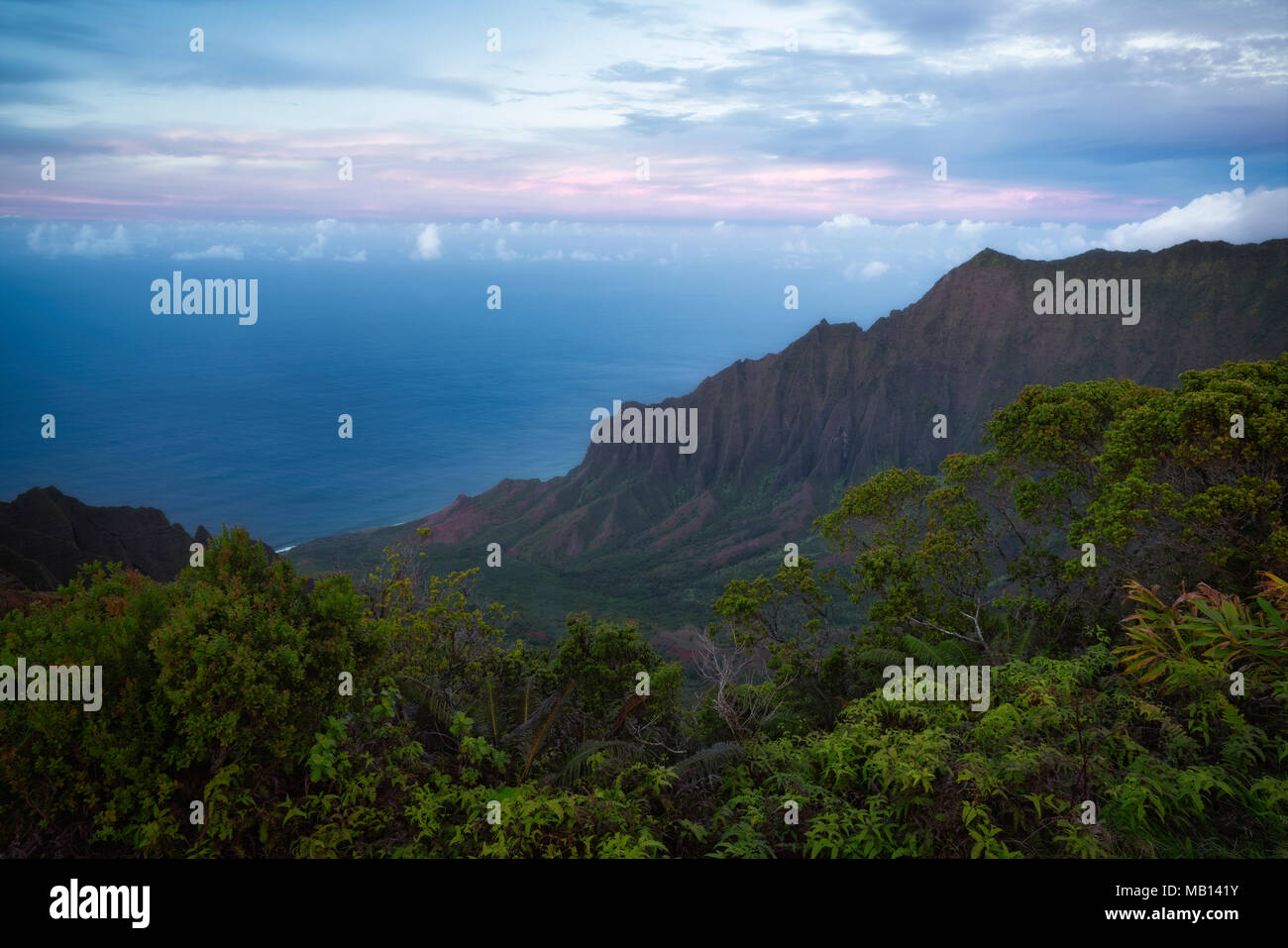 Twilight over the Pacific Ocean and the Na Pali Coast on Hawaii’s Island of Kauai. Stock Photo