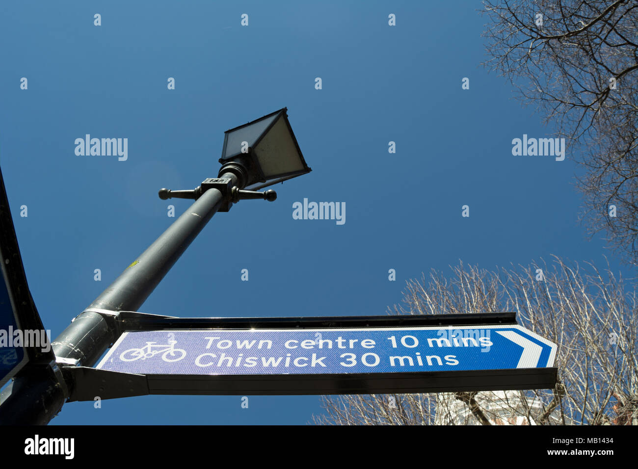 right pointing cycle route sign with directions and times to hammersmith town centre and