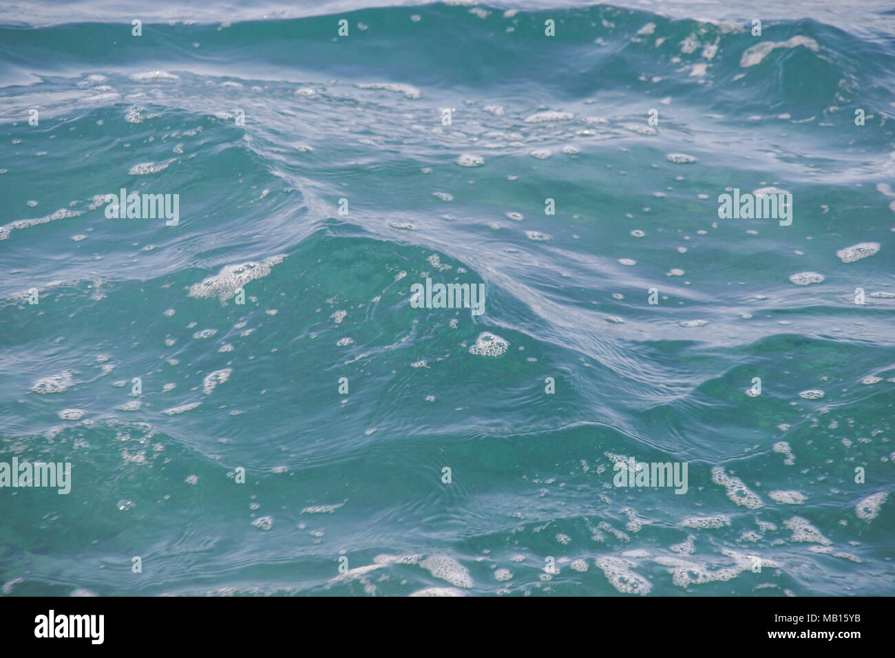 Blue sea water with waves and foam Stock Photo - Alamy