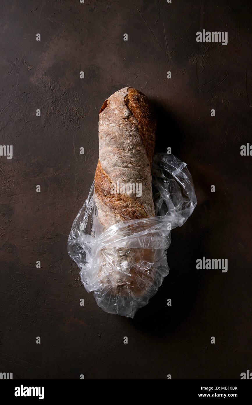 Loaf of fresh baked artisan whole grain ciabatta bread in plastic bag ...