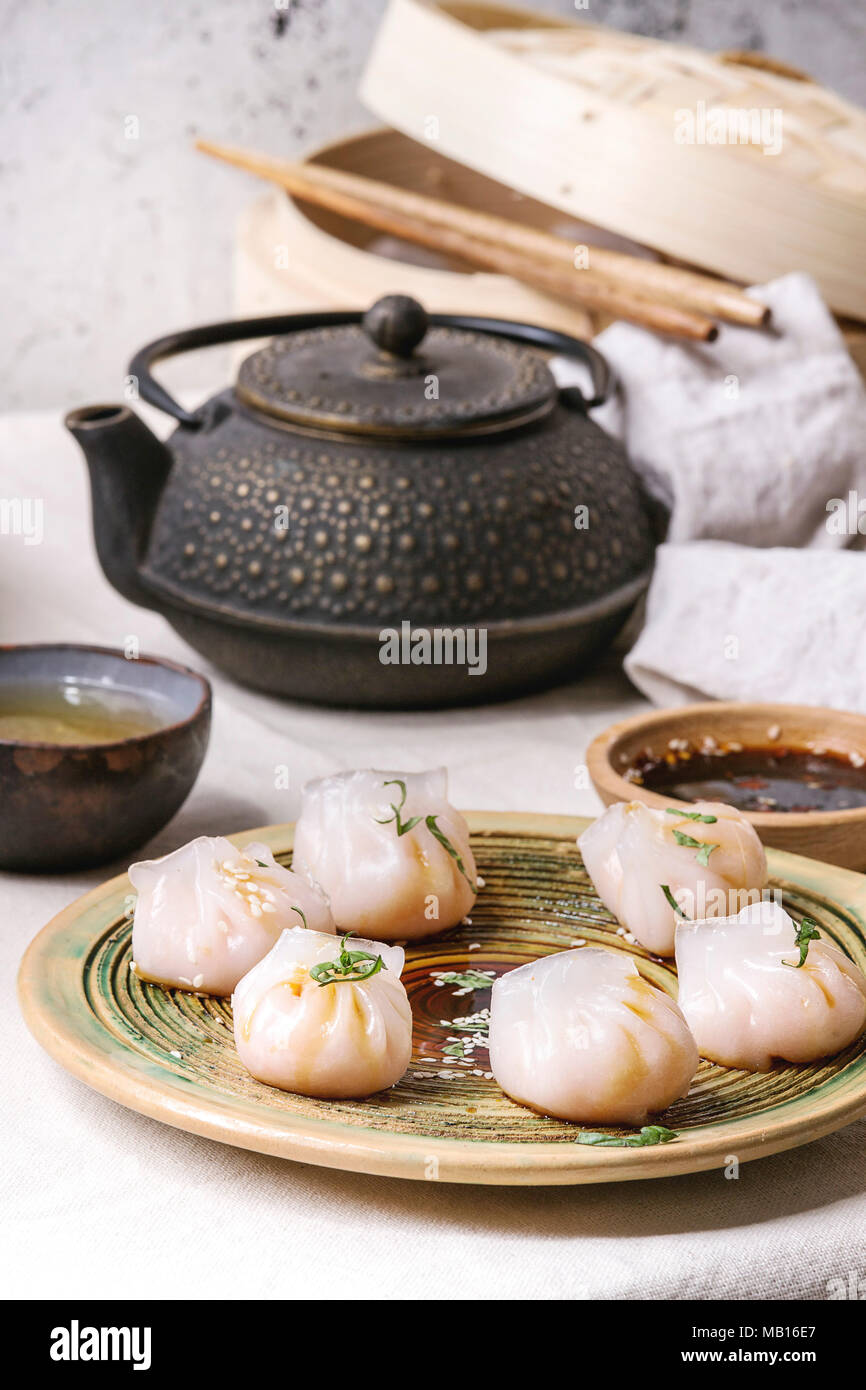 Asian steam potstickers dumplings stuffed by shrimps, served on ceramic plate with soy sesame