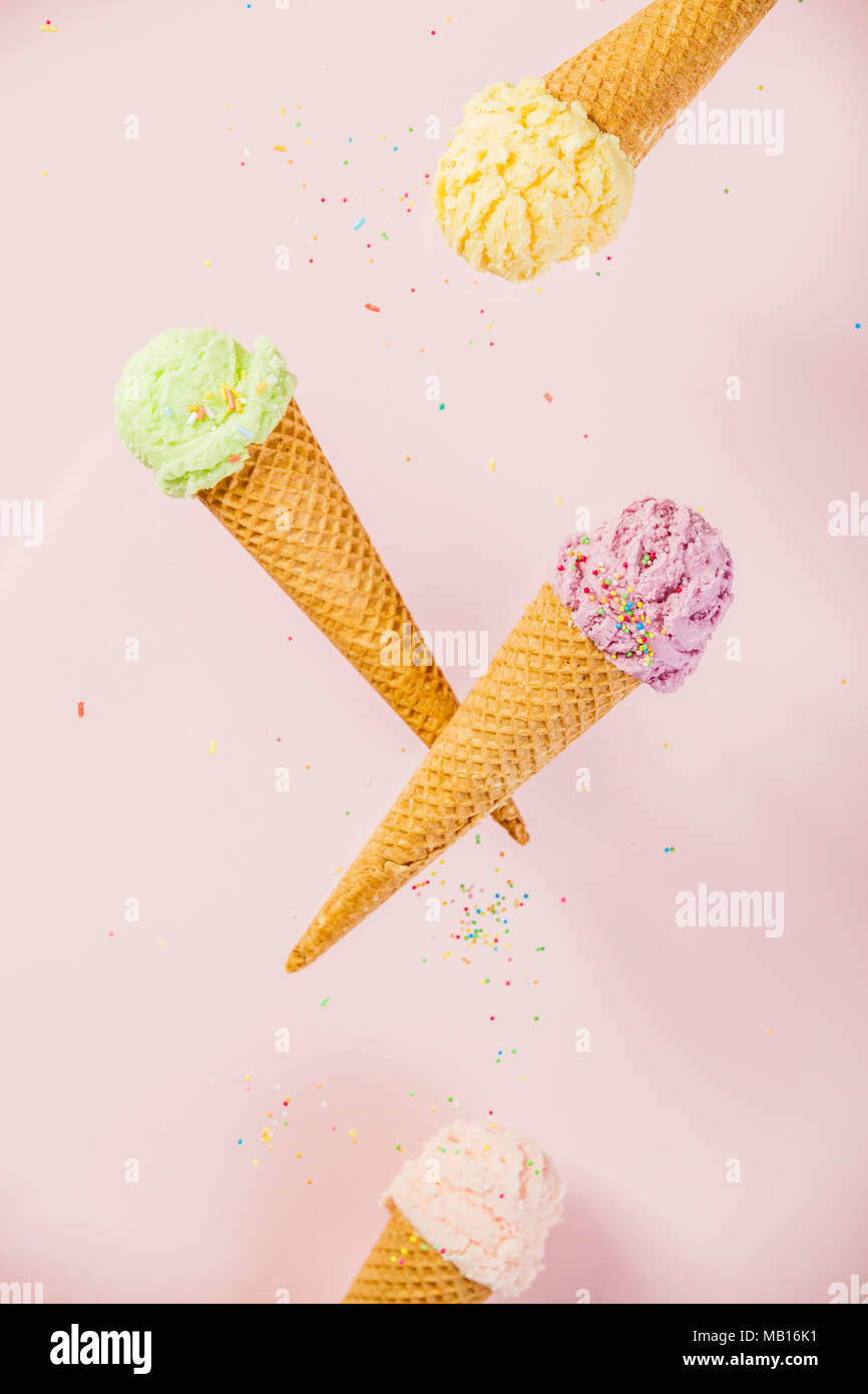 Colorful Ice Cream in a waffle cones on pink background Stock Photo - Alamy