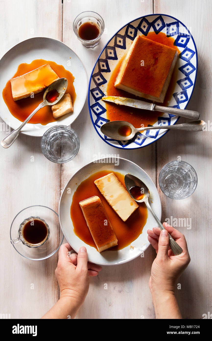 Female eating french dessert creme caramel.Top view Stock Photo - Alamy