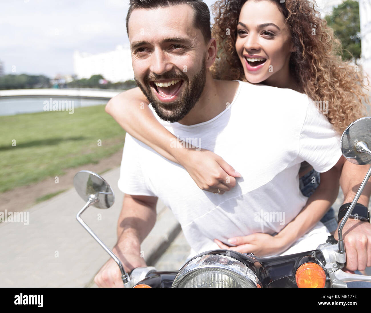 Happy Riding Happy cheerful couple riding vintage scooter outdoors Stock Photo - Alamy