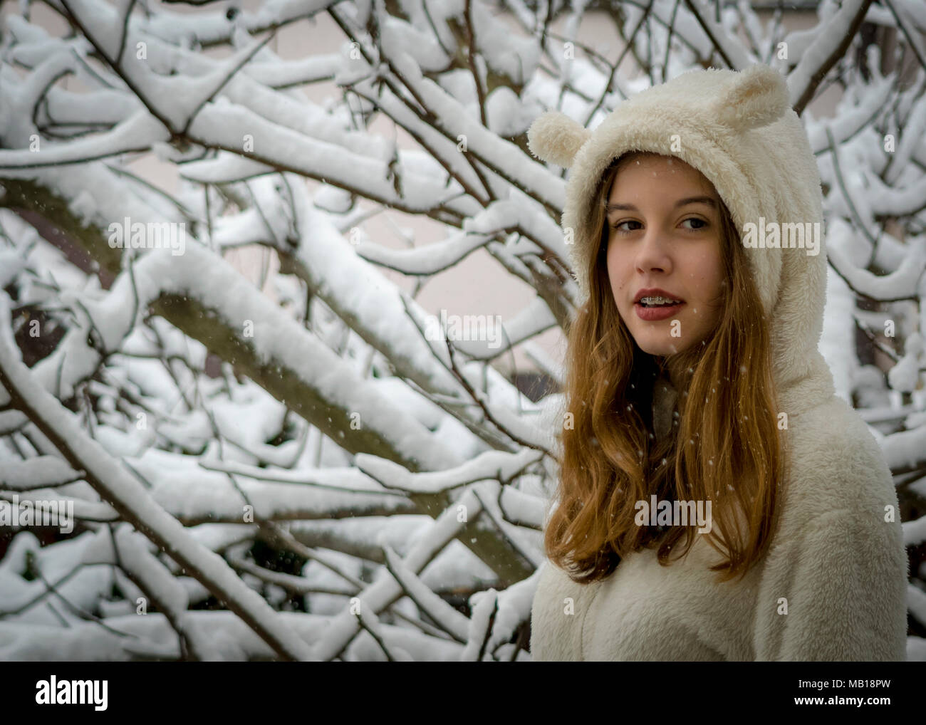 Portrait Of Teenage Girl With Snowflake In Winter Stock Photo