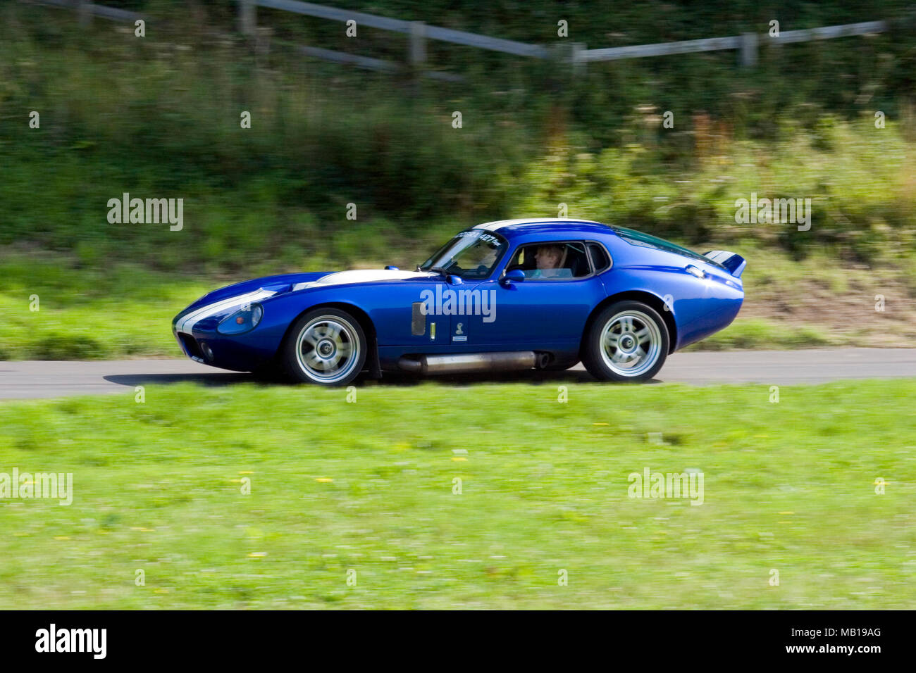 Blue Shelby Daytona Coupe 427 classic and rare American sportscar driving fast in profile (side view). Stock Photo