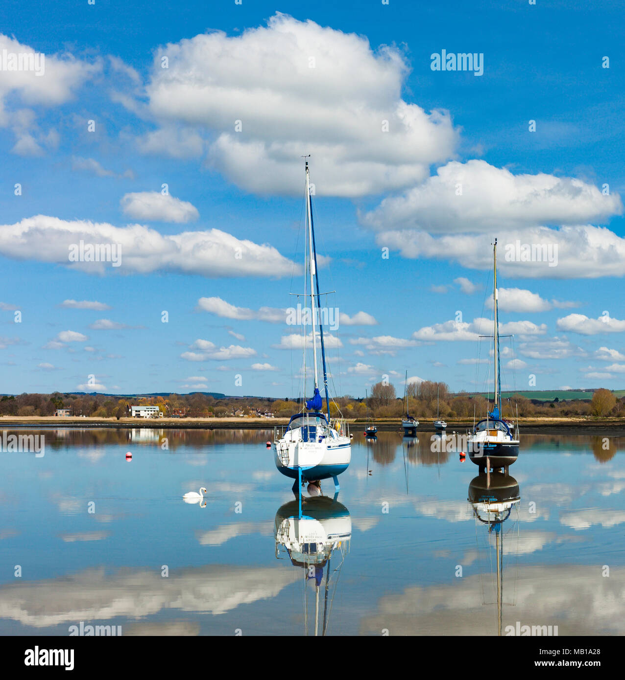 Sailing boats moored in still waters, Dell Quay, Chichester harbour. Stock Photo