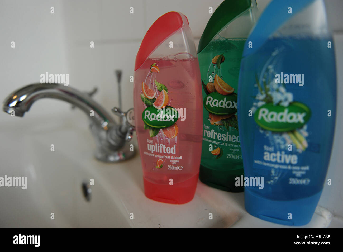 Radox toiletries lined up in a bathroom Stock Photo