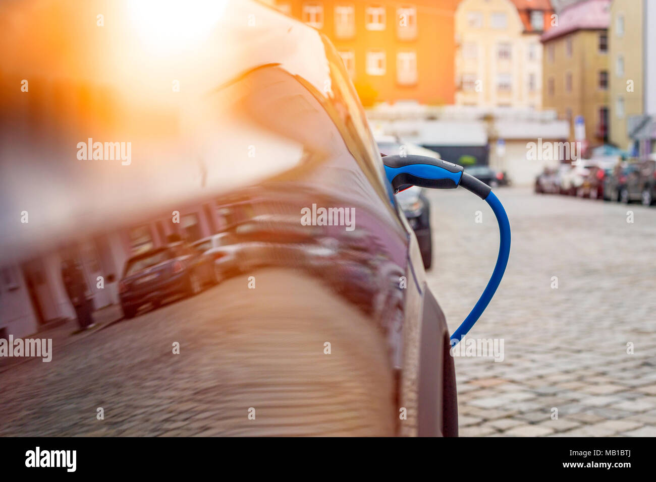 Close up of the power supply plugged into an electric car being charged Stock Photo