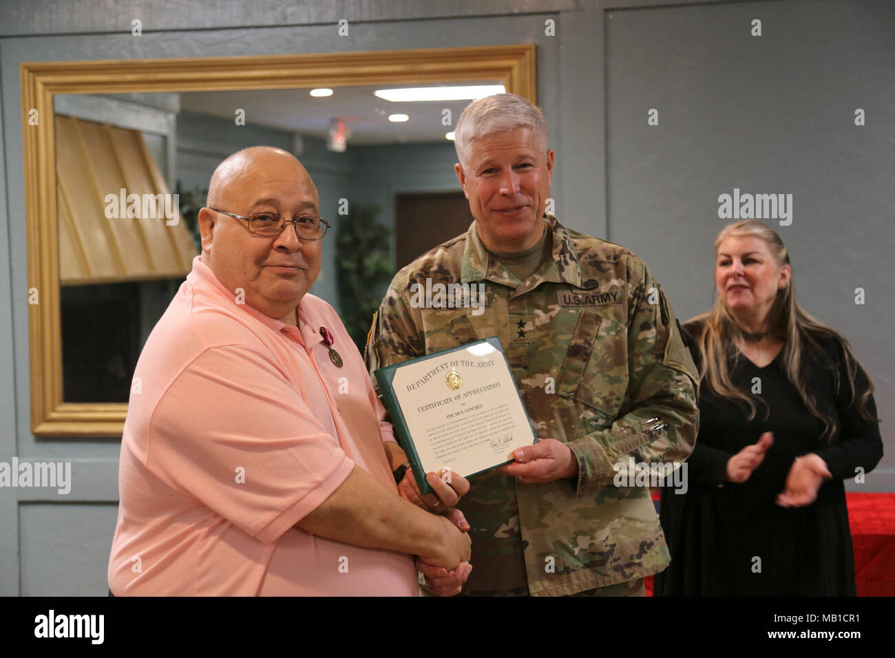 Oscar Sanchez receives a letter of appreciation from the Commander of the 81st Regional Support Command, MG Arlen DeBlieck, during his retirement ceremony held on Fort Jackson, SC, for his nearly 50 years of service to the U.S. Army Reserve. Stock Photo