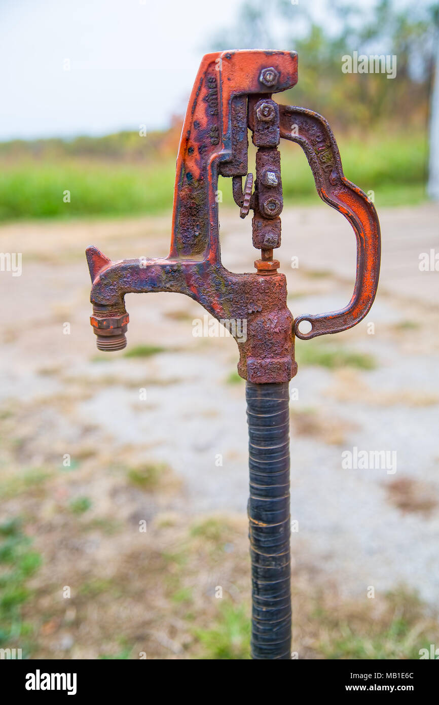 Old rusted hand pump water spigot used on a farm Stock Photo
