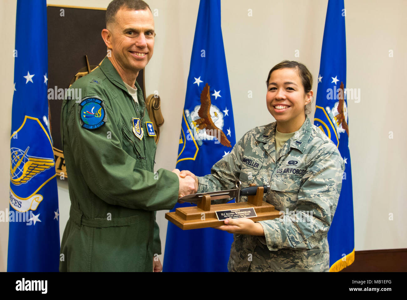 First Lt. Allyssa Schimmoeller is presented with the 2017 Volunteer of the Year award for Headquarters Pacific Air Forces from Brig. Gen. Gregory Guillot, Headquarters PACAF chief of staff, during the 2017 Outstanding Airman of the Year ceremony Feb. 9, 2018, at Joint Base Pearl Harbor-Hickam, Hawaii. Outstanding Airman of the Year awards are presented to recipients who have demonstrated superior leadership, job performance and personal achievement throughout the year. Stock Photo