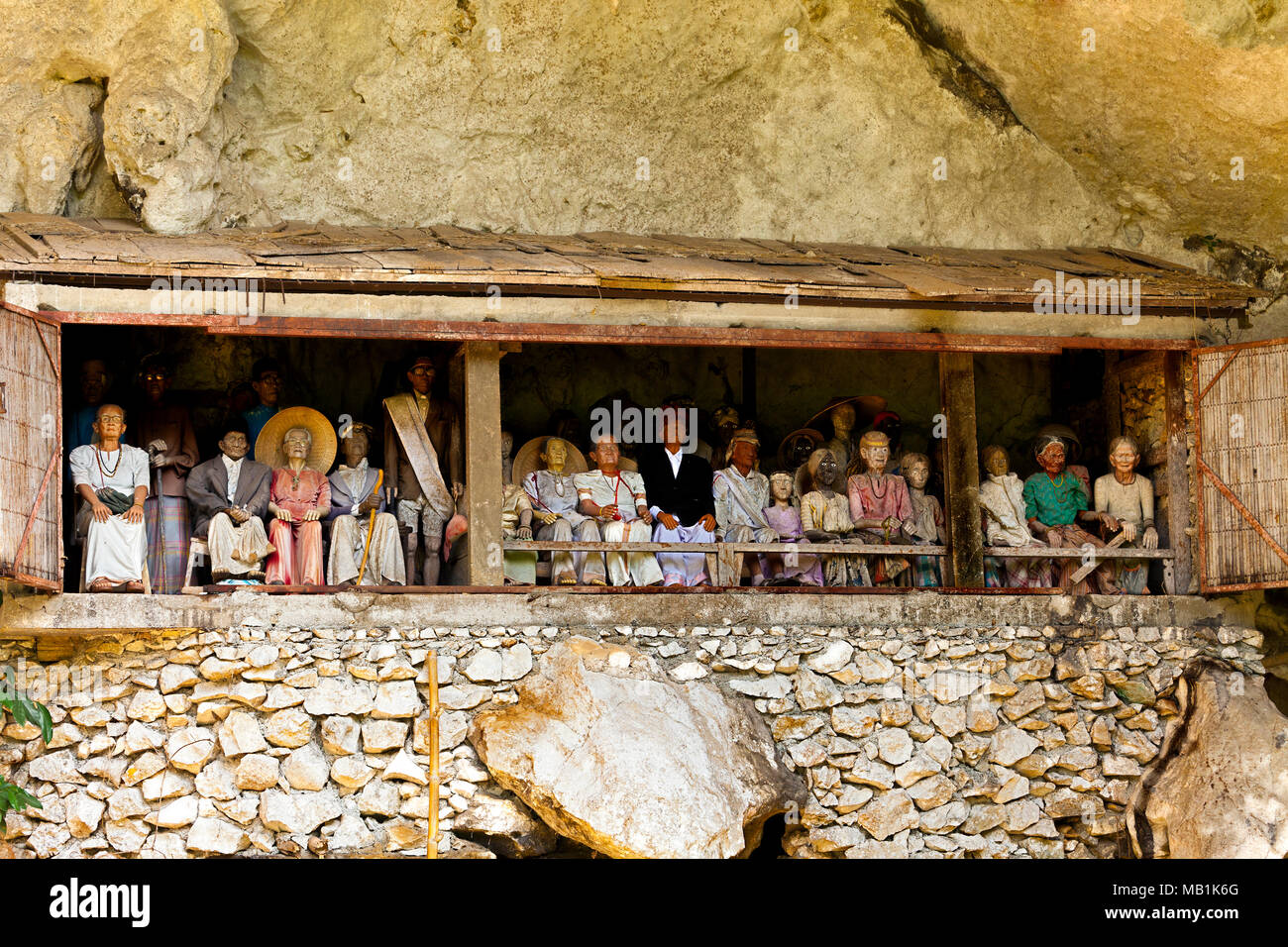 Tana Toraja burial customs - effigies are often made to represent the deceased person. The coffin is placed in a cave. South Sulawesi, Indonesia. Stock Photo