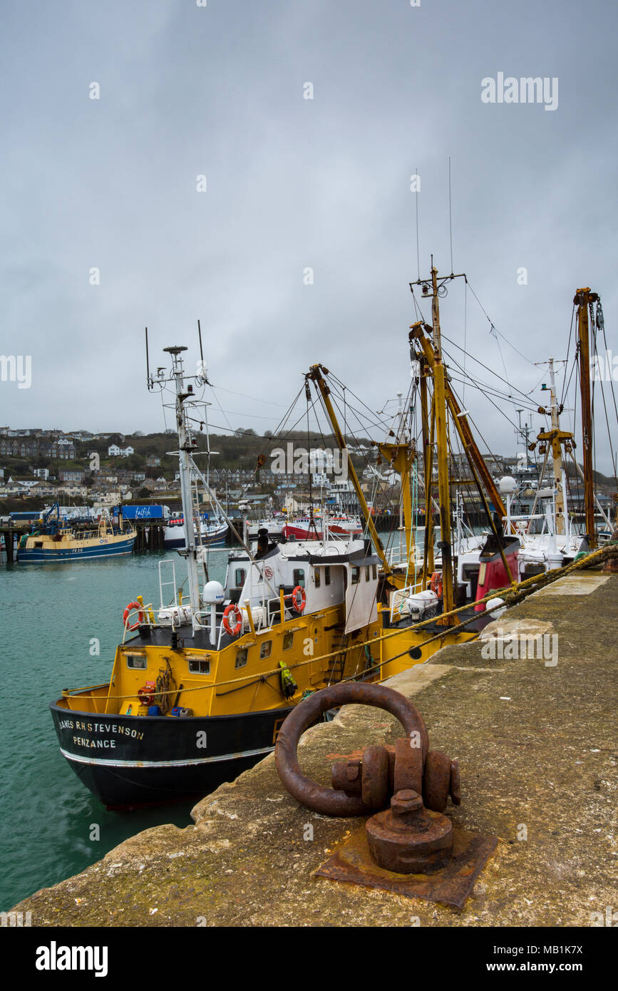 Fishing boats and trawlers from the Stevenson fleet at Newlyn in west cornwall near Penzance. Deep sea fishermen and trawling vessels tied up and idle Stock Photo