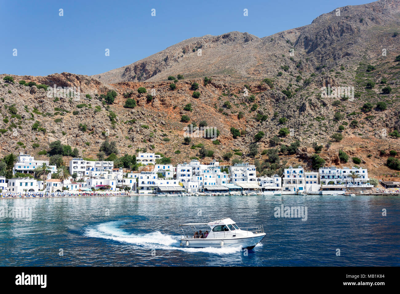 View of village and harbour from sea, Loutro, Sfakia, Chania Region, Crete (Kriti), Greece Stock Photo