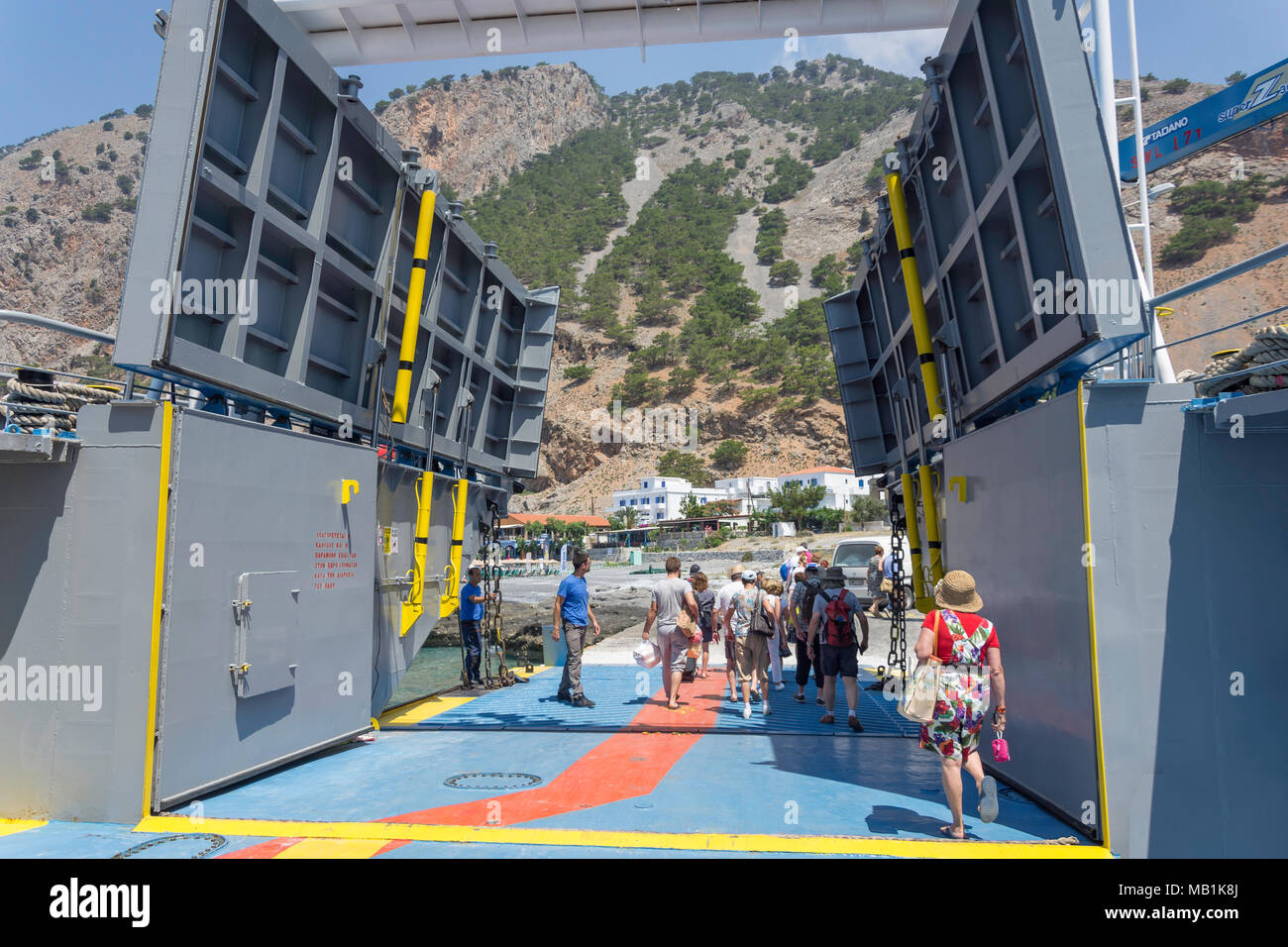 Passengers leaving car ferry at port of Agia Roumeli, Sfakia, Chania Region, Crete (Kriti), Greece Stock Photo