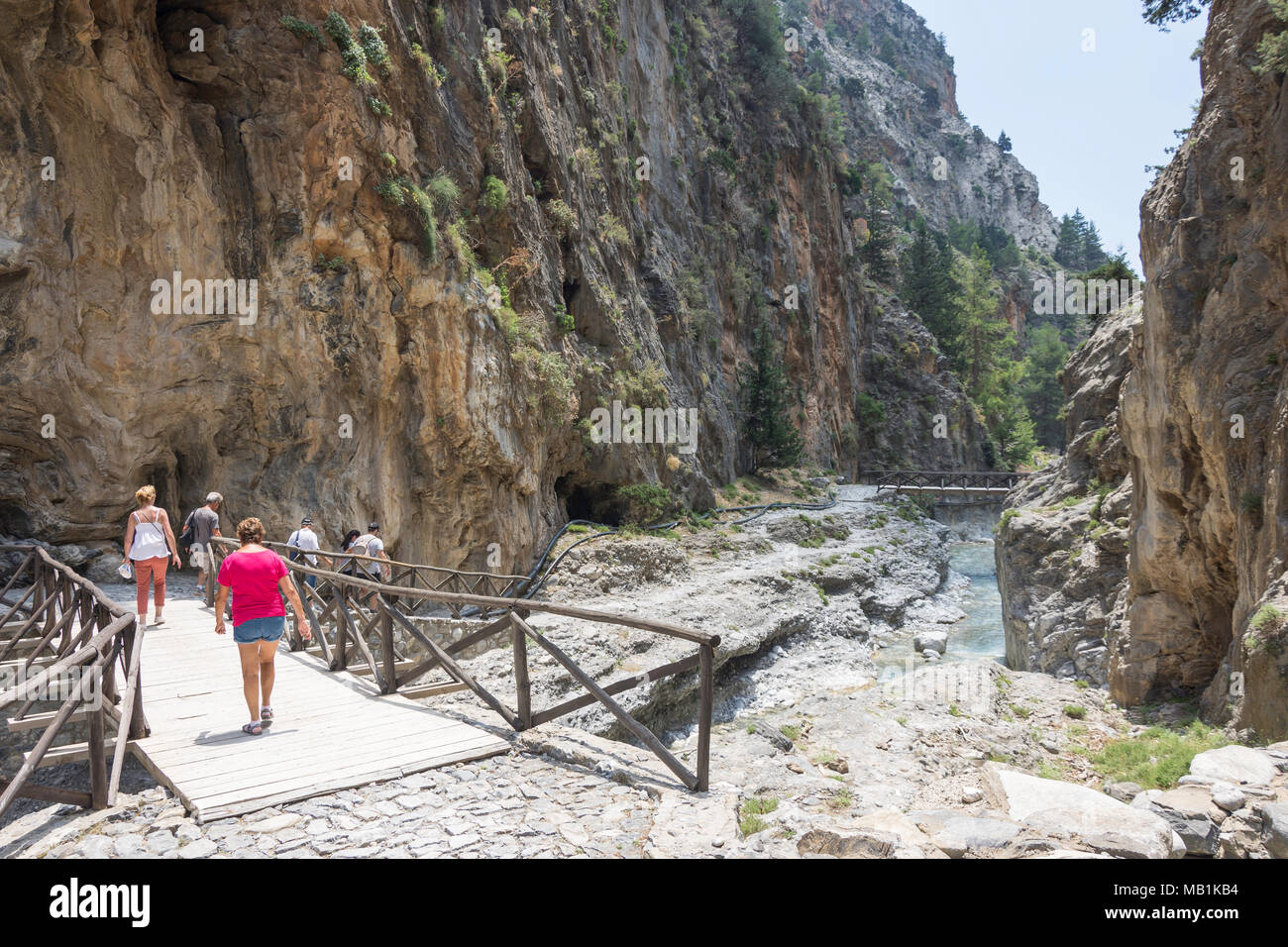 Walkers walking through narrow Portes section of the Samaria Gorge. Agia Roumeli, Sfakia, Chania Region, Crete (Kriti), Greece Stock Photo