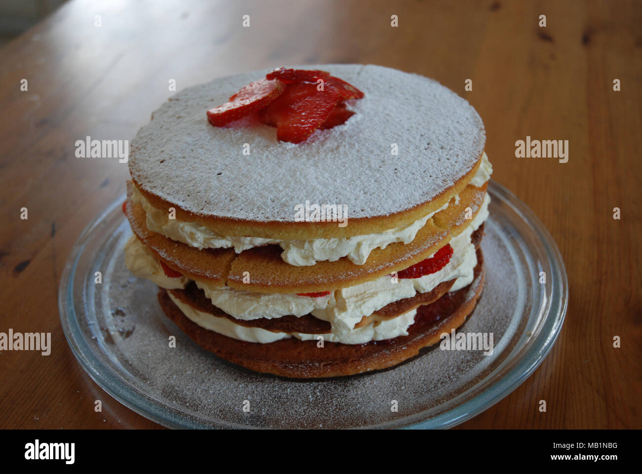 1st attempt at making a 3 tiered strawberry and cream victoria sponge cake with homemade jam Stock Photo