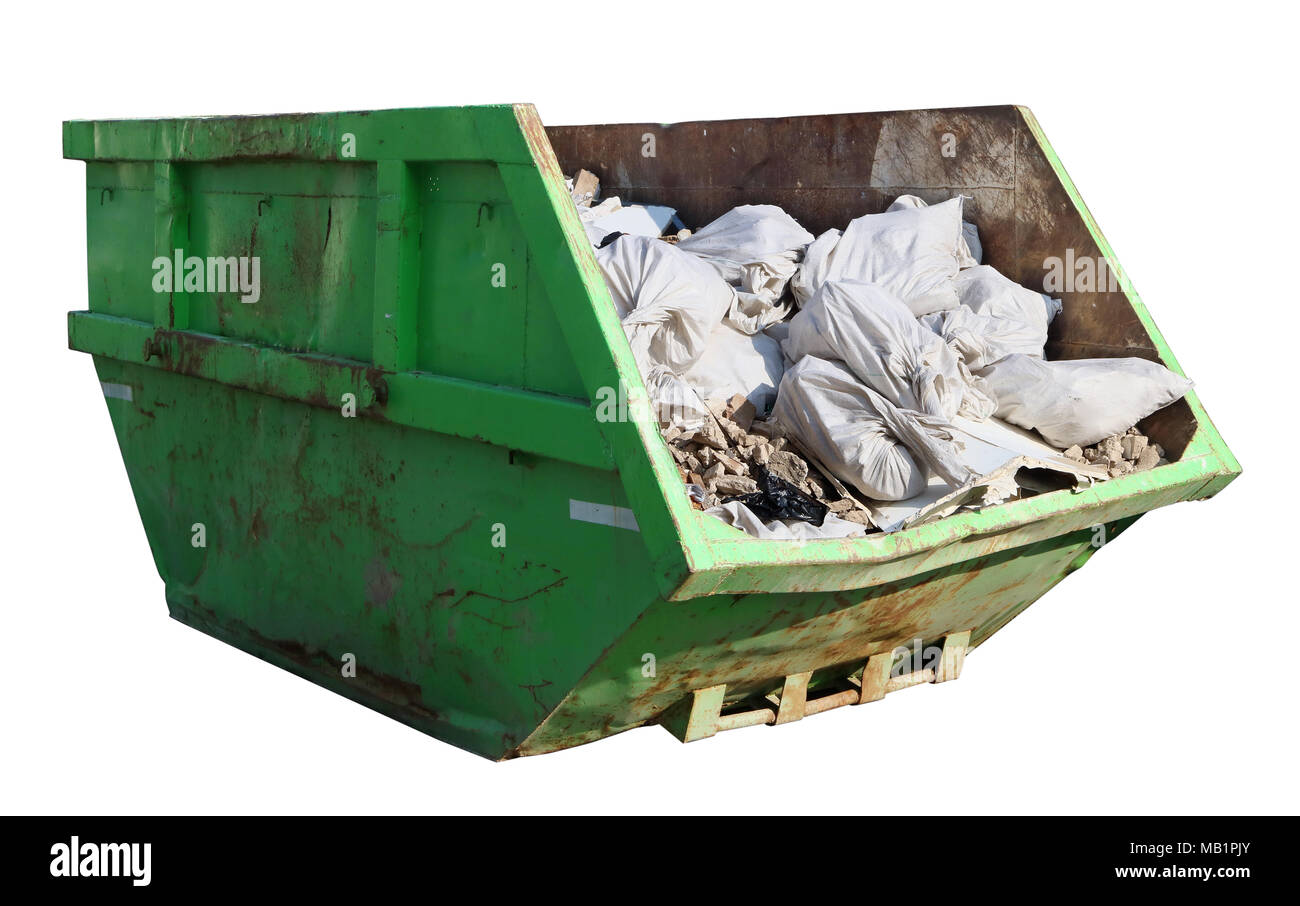 Crushed rusty green  garbage container filled with construction debris. Isolated  on white with patch sunny day shot Stock Photo