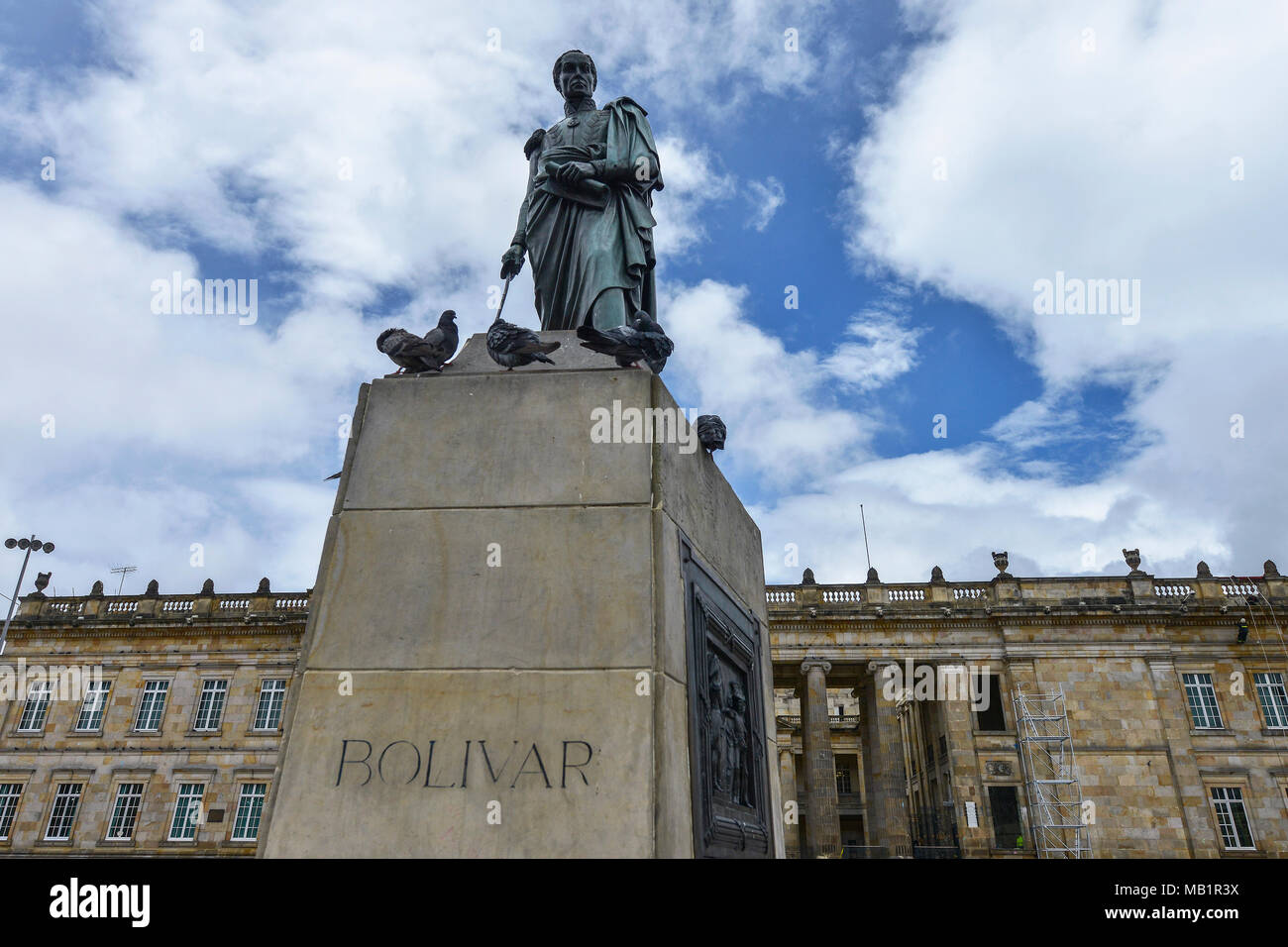 Statue of Simon Bolivar in the Bolivar square with the National Capitol in the background in Bogota, Colombia. Stock Photo