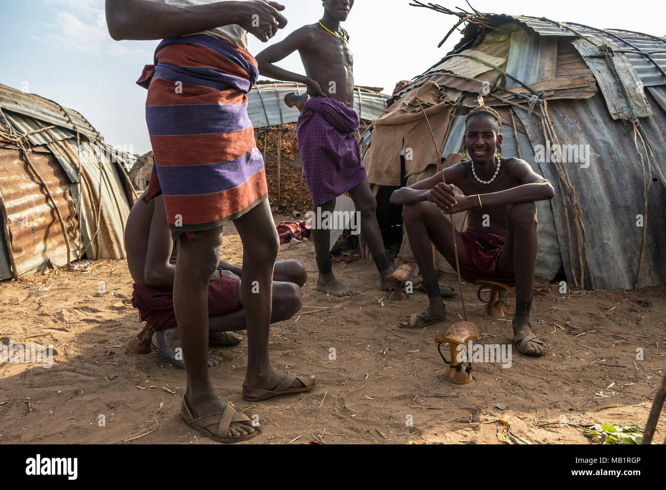 Omorate, Ethiopia - January 25, 2018: Unidentified men from the Dassanech tribe making chairs in their village in Omorate, Ethiopia. Stock Photo