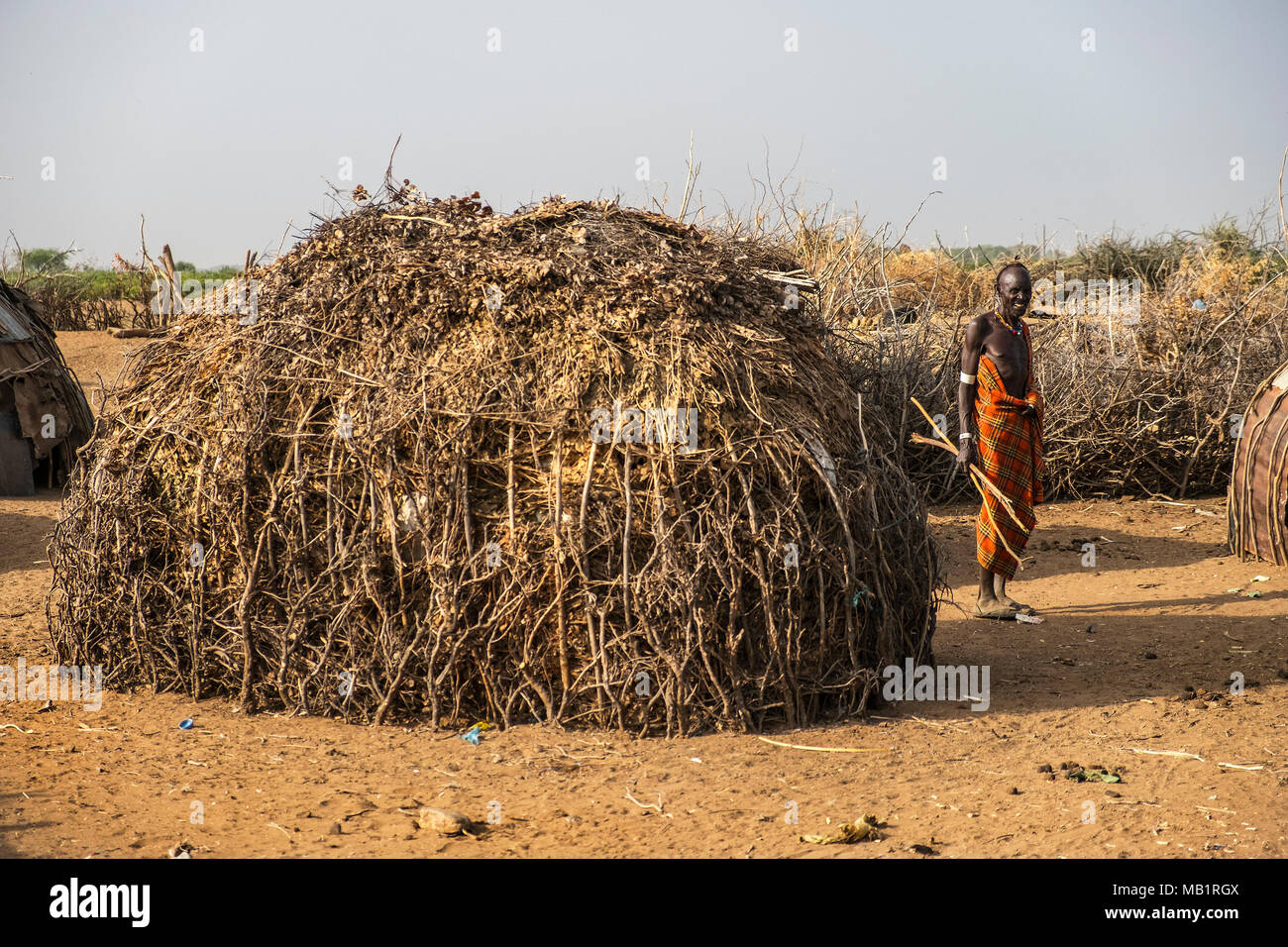 Omorate, Ethiopia - January 25, 2018: Man from the Dassanech tribe in his village next to his house in Ethiopia. Stock Photo