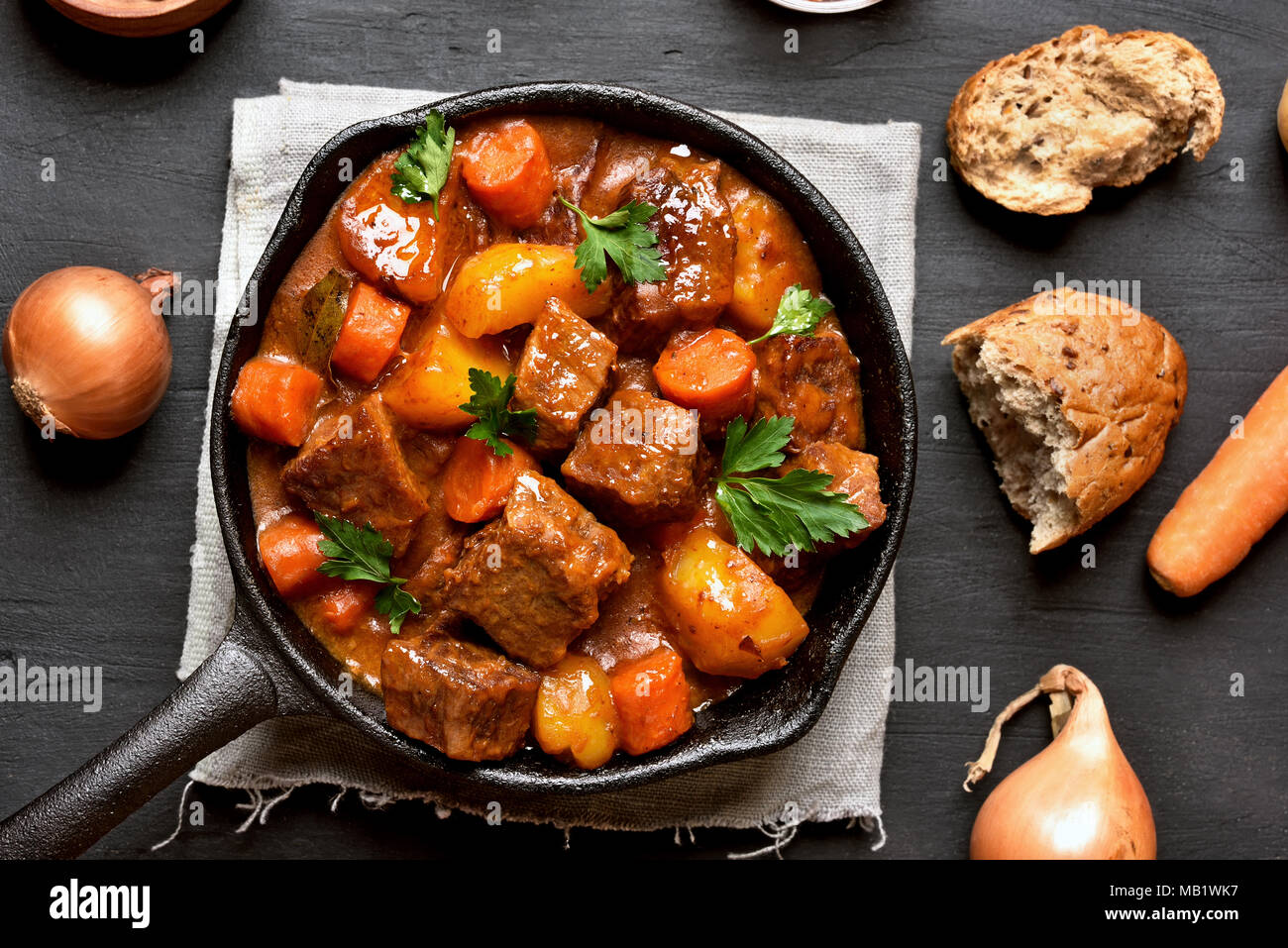 Goulash, beef stew in cast iron pan, top view, close up Stock Photo