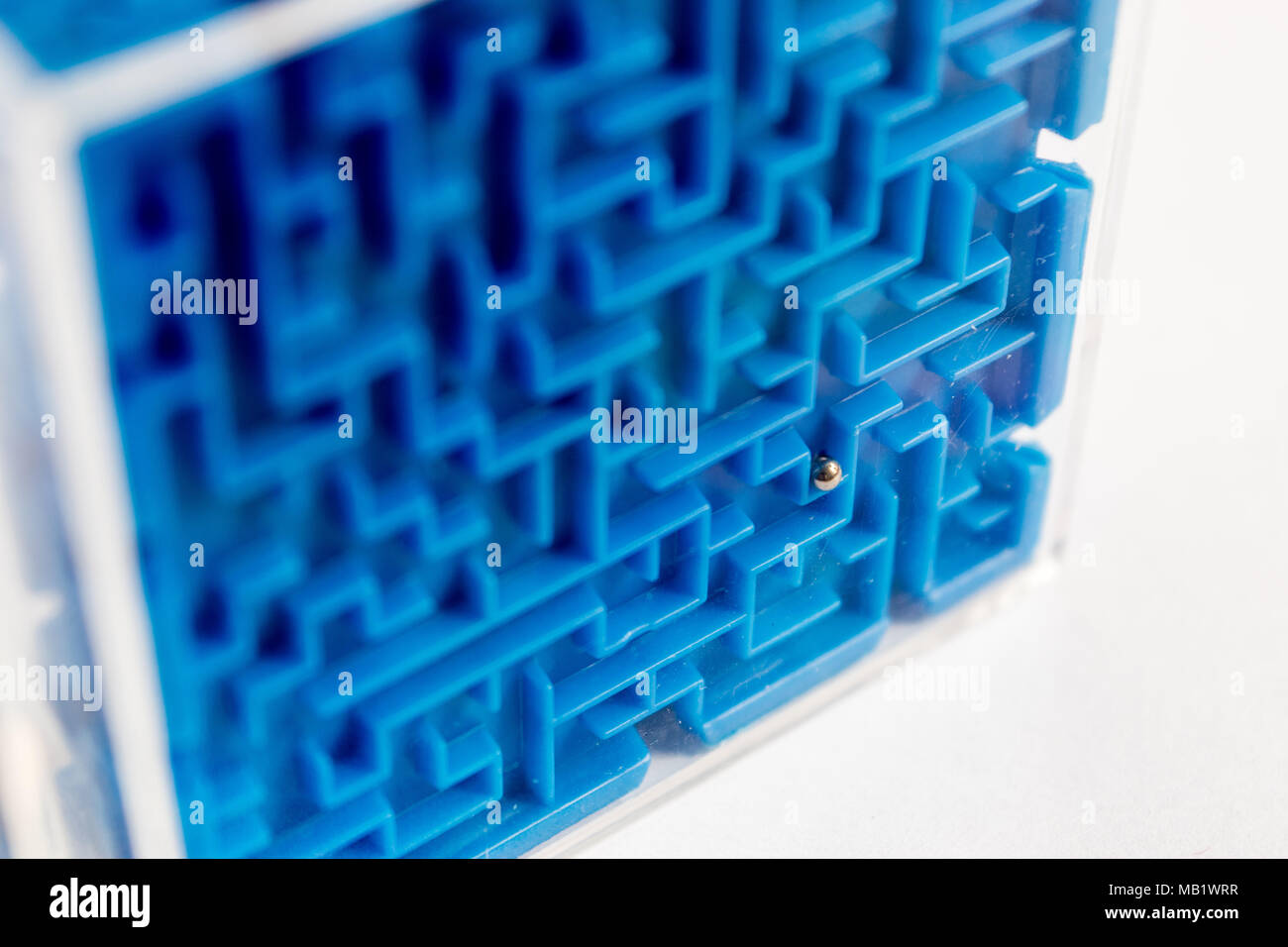 Blue toy maze with metal ball inside Stock Photo