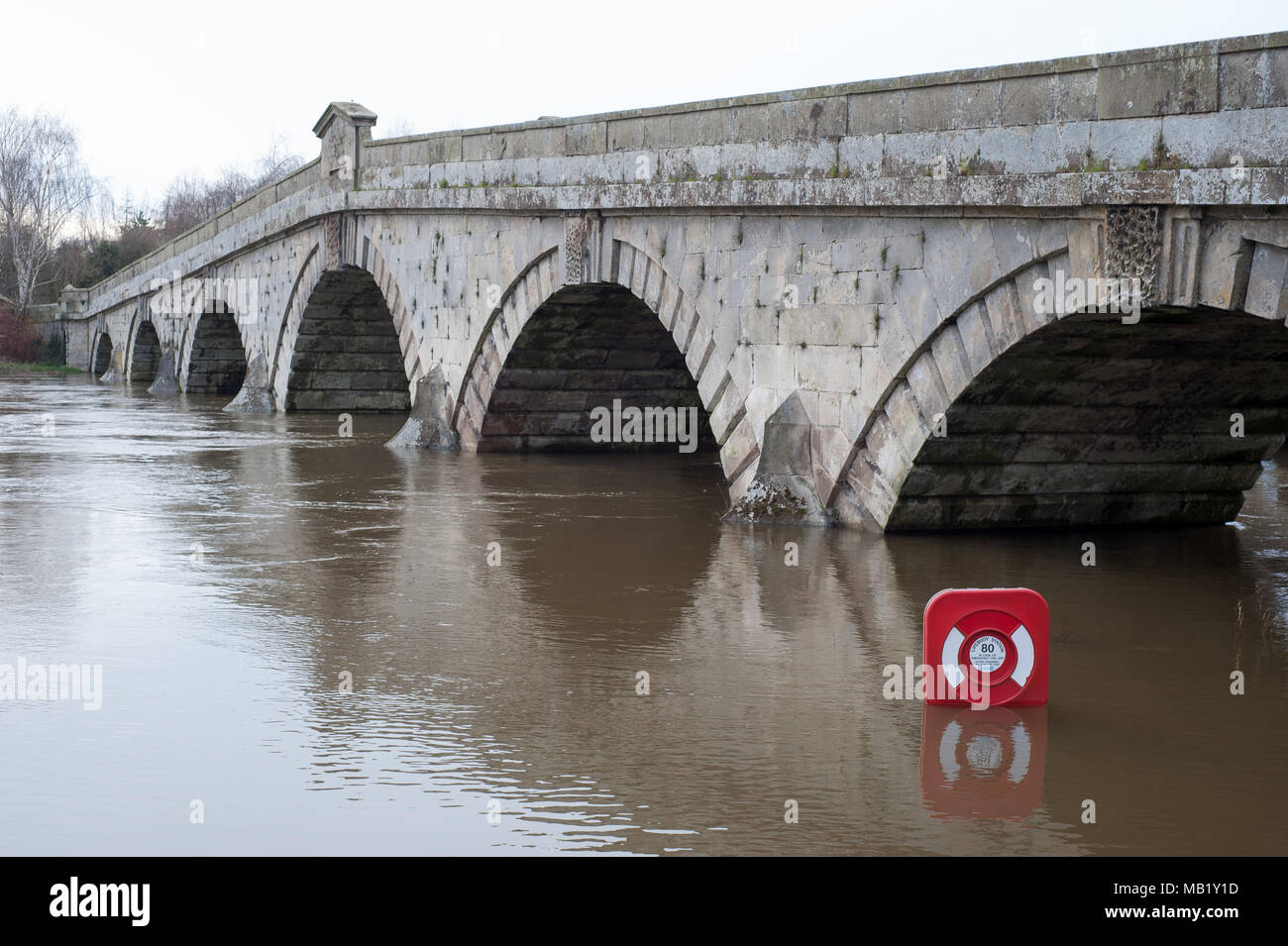 Historic 18th century footbridge and 20th century road bridge at Atcham, Shropshire, England over flooded River Severn in springtime Stock Photo