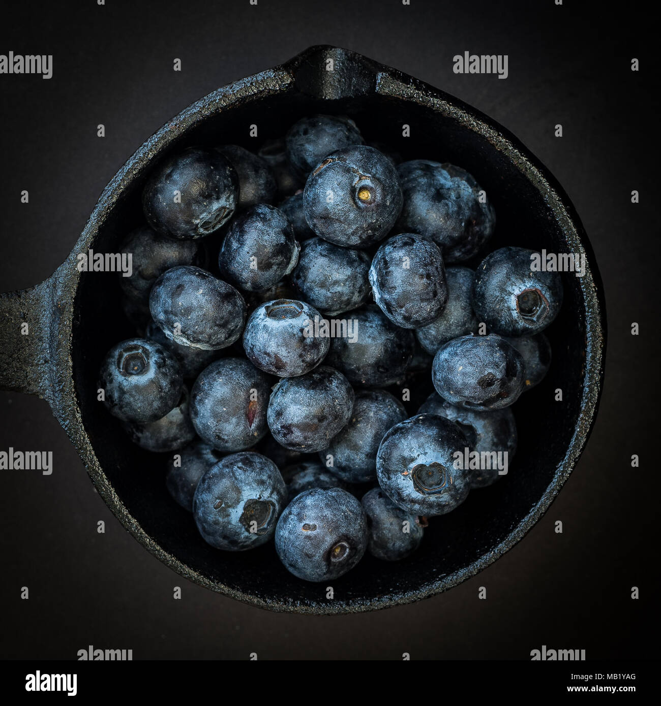Blueberries shot overhead, in a dark food style with vignette Stock Photo