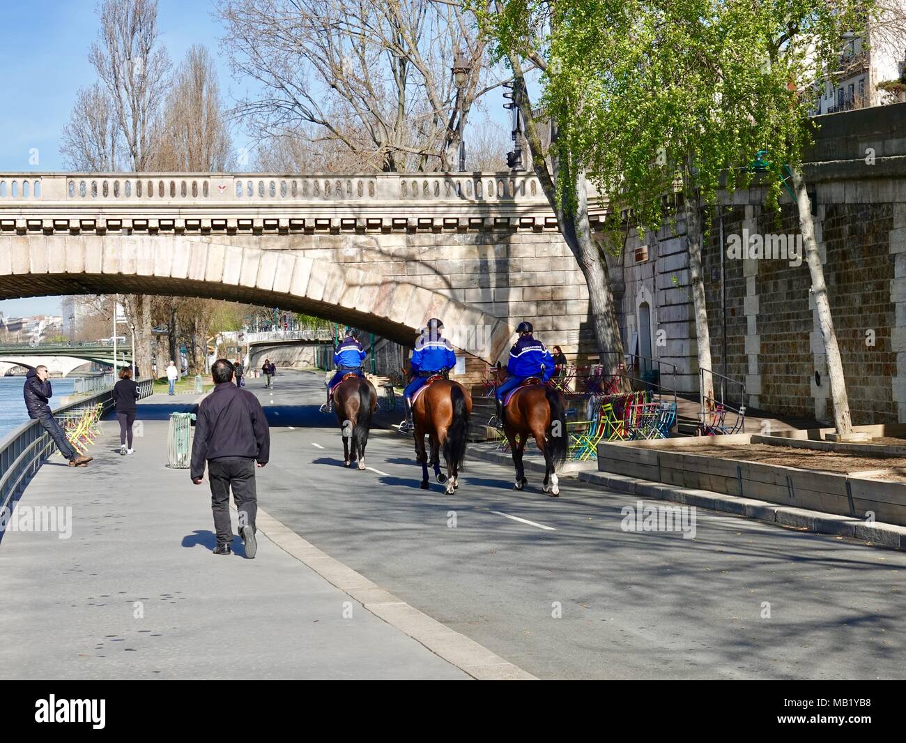 Four Gendarmes on horseback patrolling the Parc Rives de Seine. Paris, France. Stock Photo
