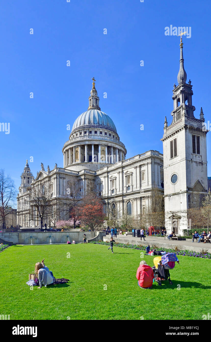 London, England, UK. Sitting on the lawn of Festival Gardens in front of St Paul's Cathedral Stock Photo