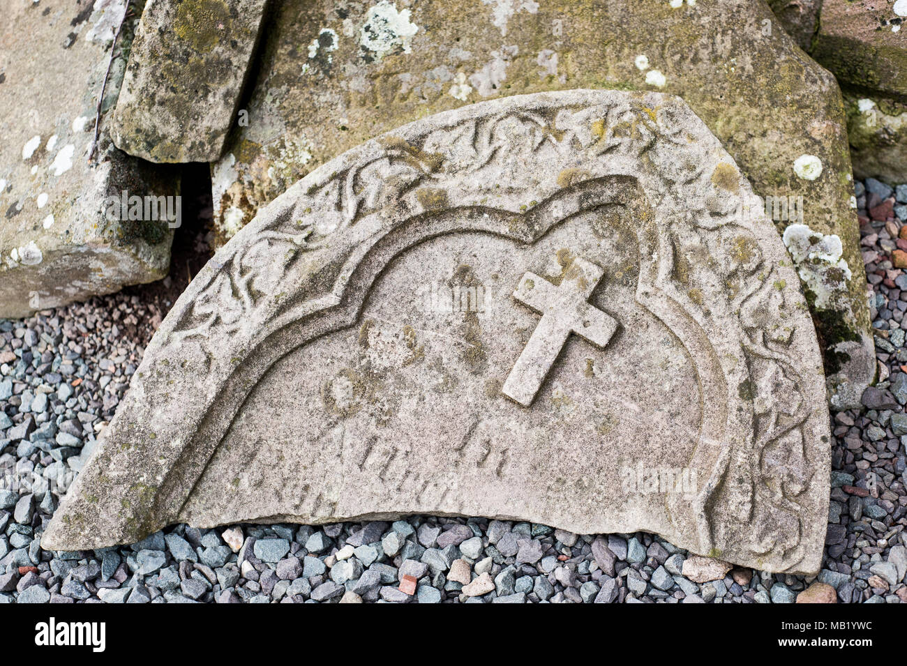 Broken headstones on graves in churchyard at historic 11th century St Eata's Church, Atcham, Shropshire, England Stock Photo