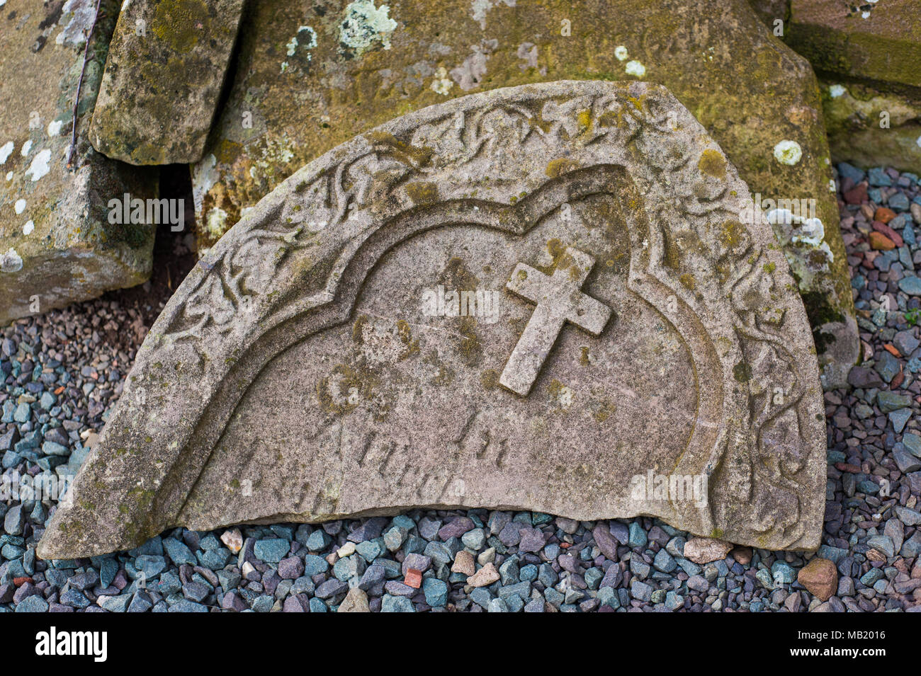 Broken headstones on graves in churchyard at historic 11th century St Eata's Church, Atcham, Shropshire, England Stock Photo