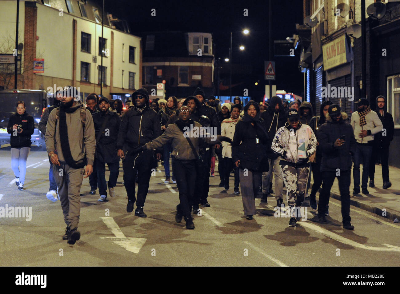 Marchers from the grassroots community organisation, GANG (Guiding A New Generation) along Morning Lane, Hackney, London, United Kingdom.  The demonstration follows the death on Wednesday (04.04.2018) of 18-year-old Israel Ogunsola who was stabbed to death and died in Link Street, Hackney. Police found him wounded after they were alerted by a motorist just before 8.00pm.   He was given first aid by police officers, but died at the scene at 8.24pm. He was initially thought to be aged in his 20s.  GANG is a youth outreach movement which focusses on the black community and implores young men in t Stock Photo