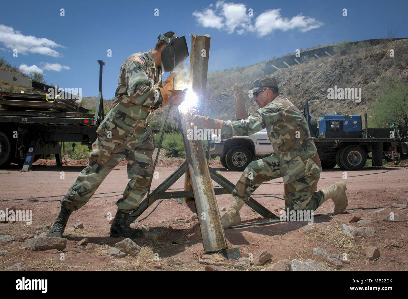 File. 4th Apr, 2018. President Trump will issue a proclamation on Wednesday directing the Department of Defense and the Department of Homeland Security to work with governors to deploy National Guard troops to the southwest border to assist the Border Patrol in combating illegal immigration. PICTURED: July 5, 2006 - Nogales, Arizona, USA - Arizona Army National Guard specialist RUBEN CORDOVA, left welds together a vehicle barrier while Sgt. first class GUSTAVO DAGINO holds the pieces in place near the US-Mexico border in Nogales, Ariz., July 5, 2006. The used railroad rails prevent vehicles Stock Photo