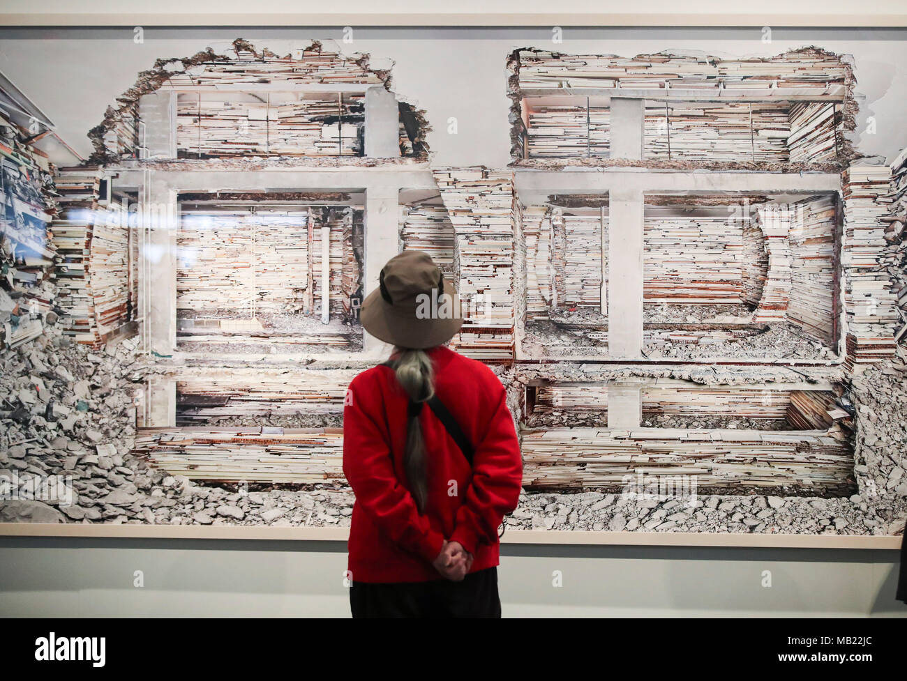 (180405) -- NEW YORK, April 5, 2018 (Xinhua) -- A visitor looks at Destroyed House Piet Mondriaanstraat 1, the photography work of Dutch photographer Marjan Teeuwen, at AIPAD (Association of International Photography Art Dealers)'s The Photography Show in New York, the United States, on April 5, 2018. The 38th edition of The Photography Show is held from April 5 to April 8. Around 100 of the world's leading fine art photography galleries present a range of museum-quality work including contemporary, modern, and 19th-century photographs, as well as photo-based art, video, and new media. (Xinhua Stock Photo