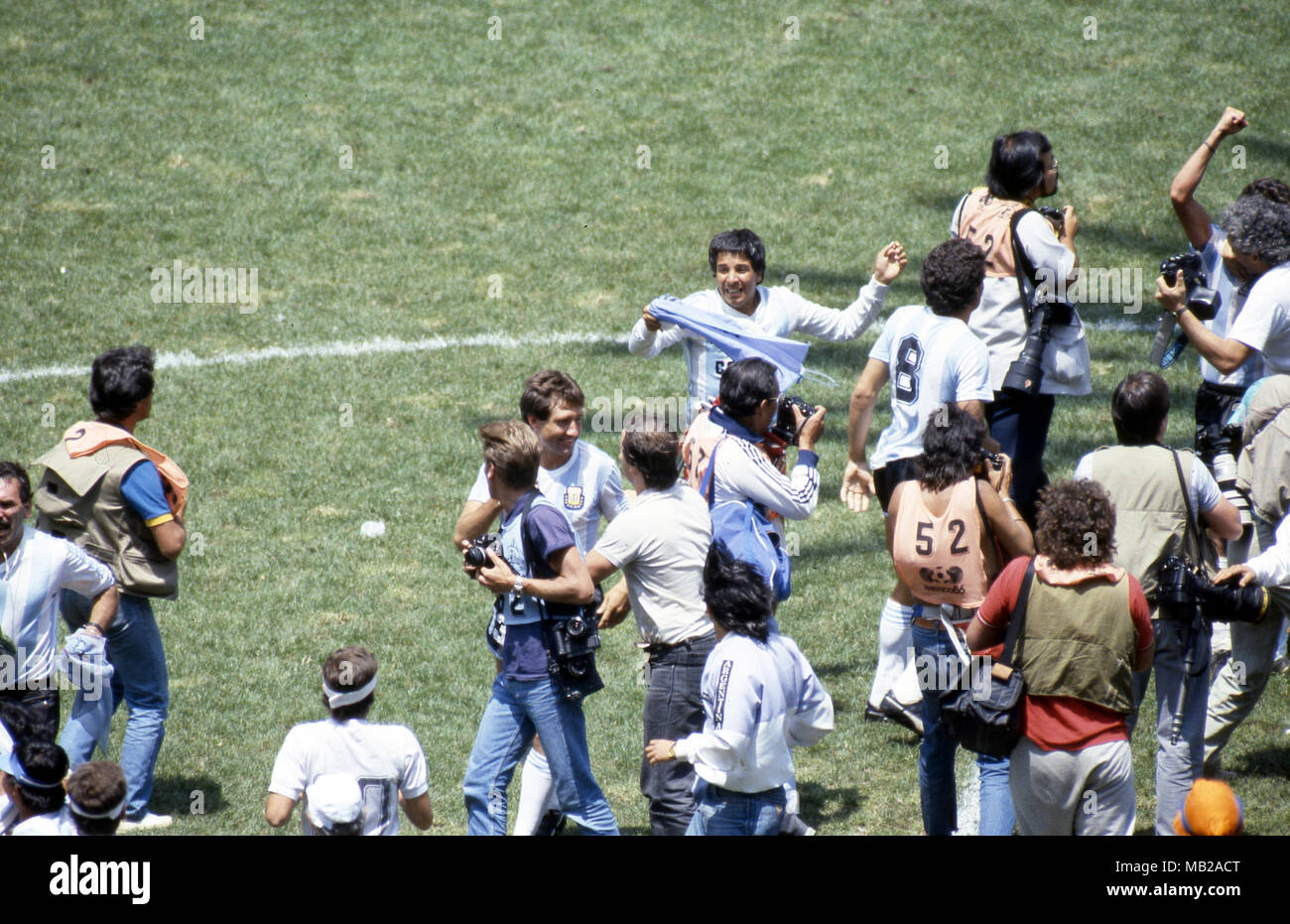 FIFA World Cup - Mexico 1986 29.6.1986, Estadio Azteca, Mexico, D.F. Final Argentina v West Germany. Photographers and elebrating fans chasing the Argentinian players on the pitch after the final whistle. In the middle Oscar Garr Stock Photo